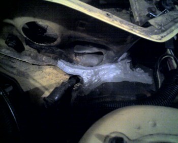 After welding the seam and its' two small stress-cracks and priming the area, I applied a high-grade automotive silicon to the outside of the area to keep it sealed.  If I have any trouble with this spot again, I will remove the silicon and go back to my original plan of using butyl-tape to seal it.