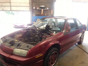 donor car getting stripped, removed engine, interior removed, tons of misc parts removed.